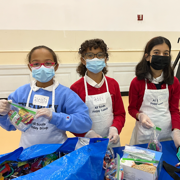 Lower School students prepare meals for the hungry at All Souls Church.