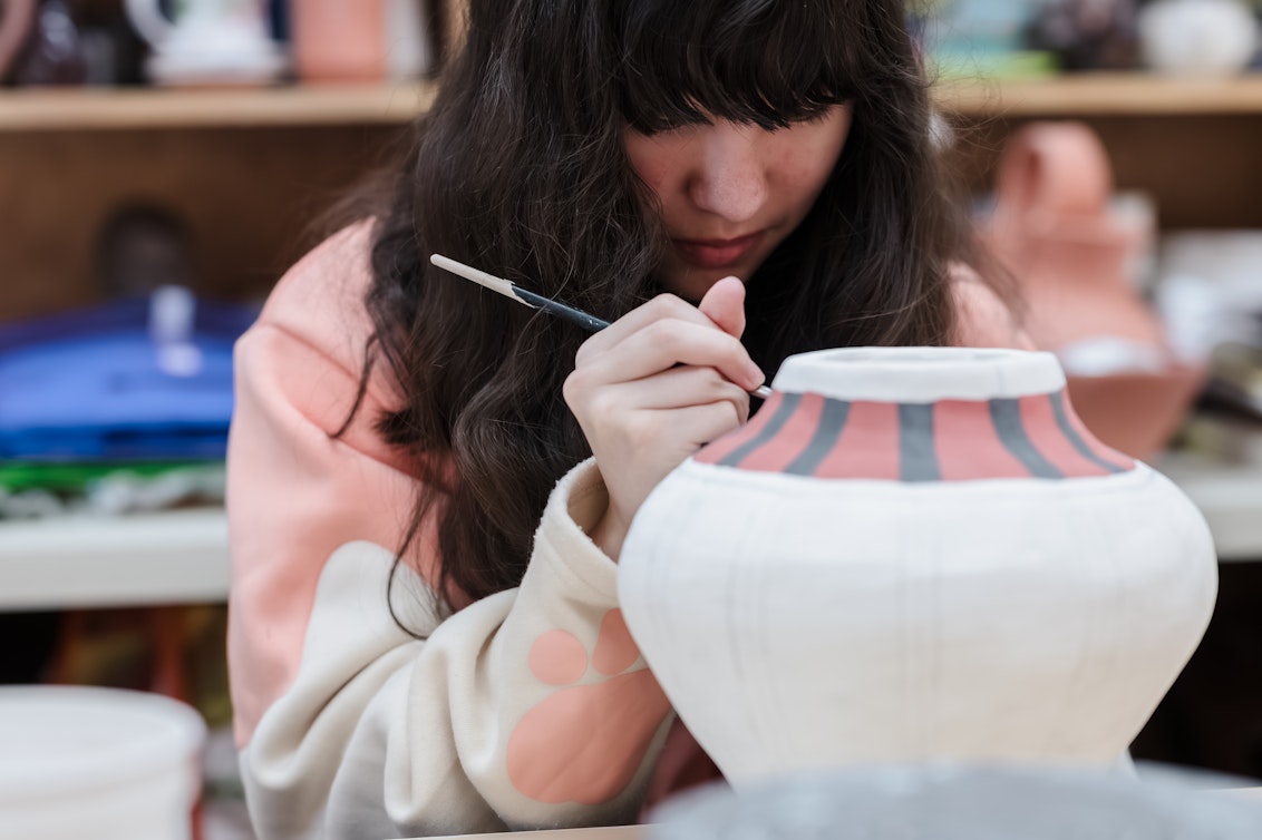 An Upper School student working on a ceramic pot as part of the Ceramic Club