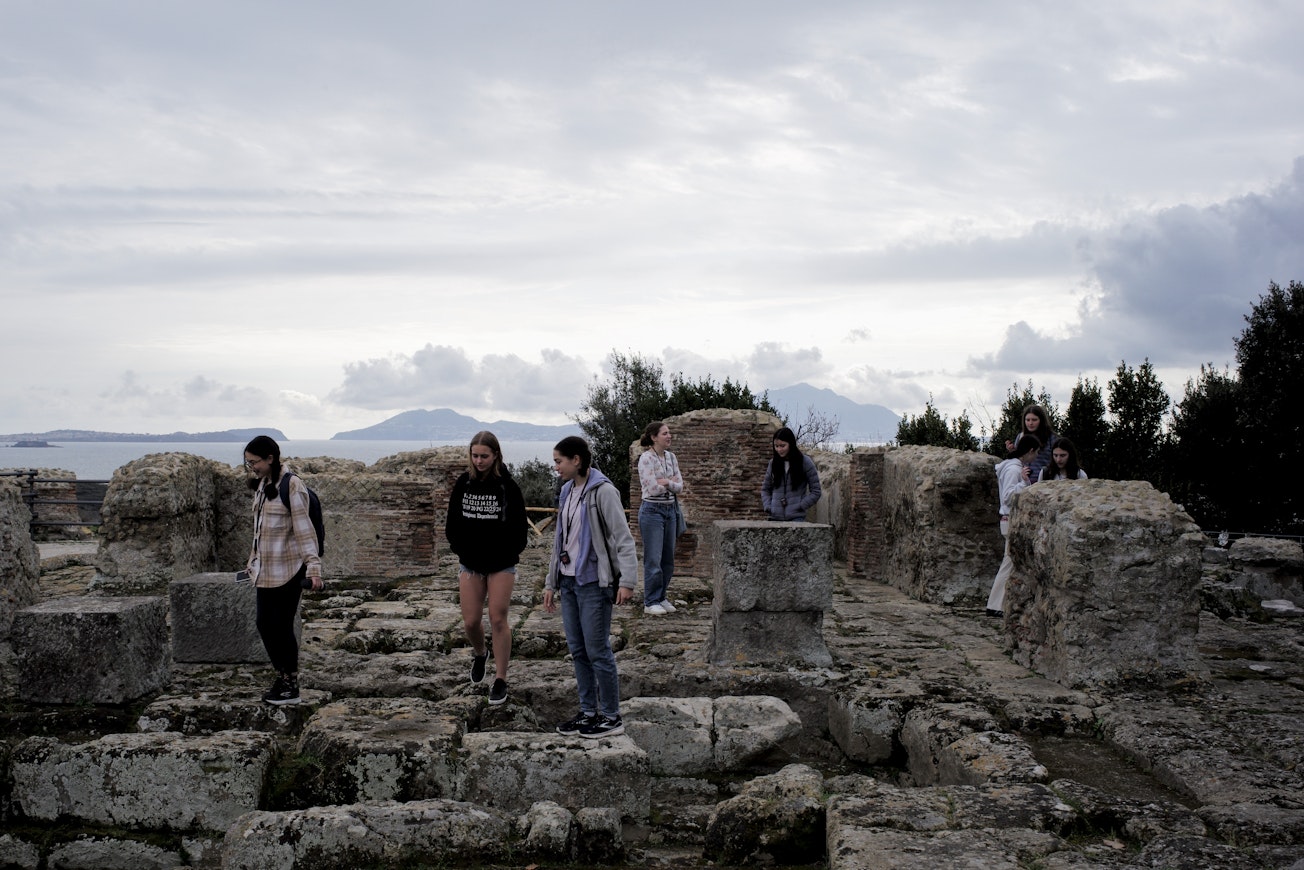 A group of Upper School students exploring ancient ruins on a trip abroad