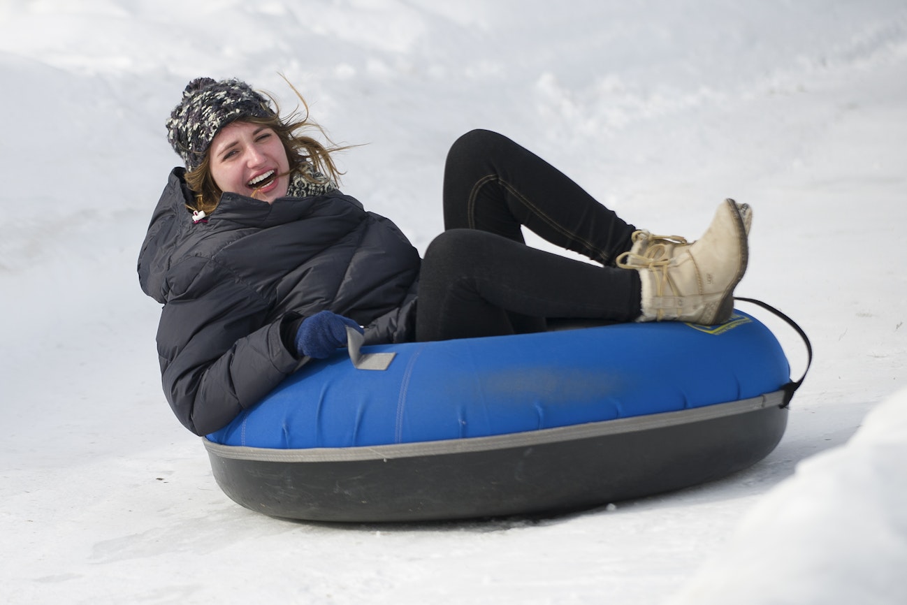 An Upper School student tubing in the snow