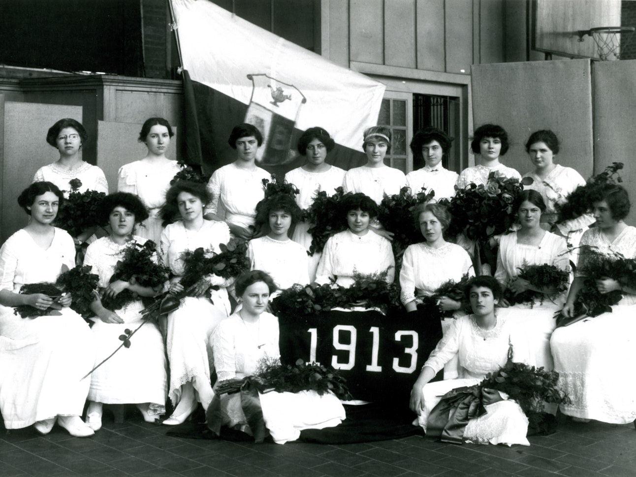 The Class of 1913 posing in their traditional white dresses for Last Day, which is Brearley's commencement ceremony.
