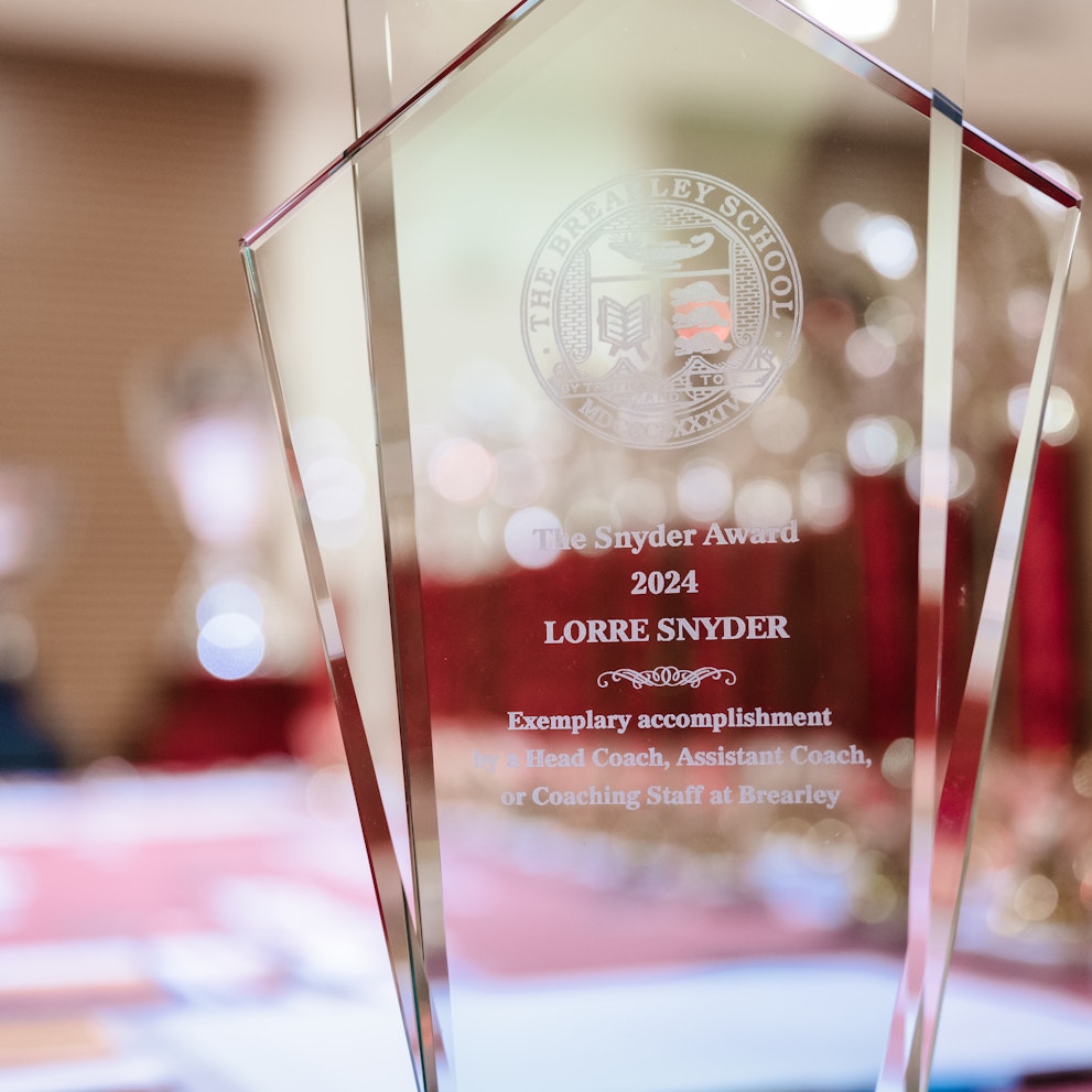 A closeup of the Lorre Snyder Coach of the Year Award