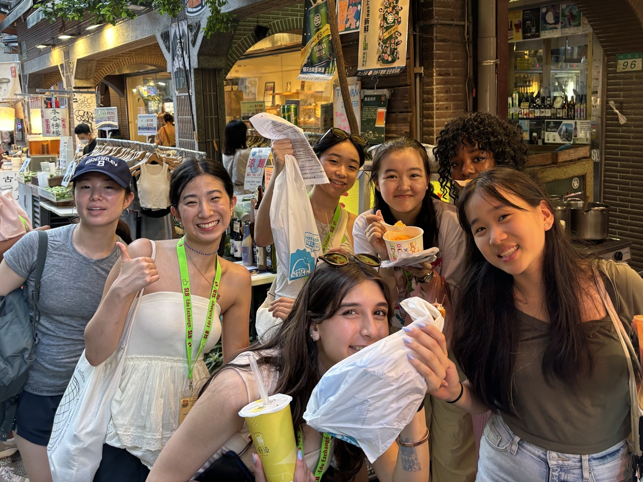 Upper School students posing with food and smiling broadly during their summer trip to Taiwan.