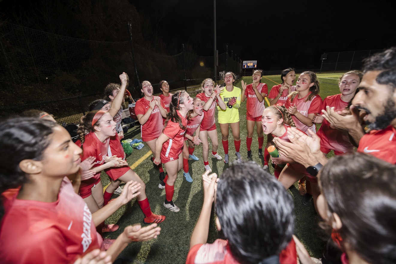 Varsity Soccer team members and coaches excitedly and enthusiastically celebrating their win at the NYSAIS Champtionship.
