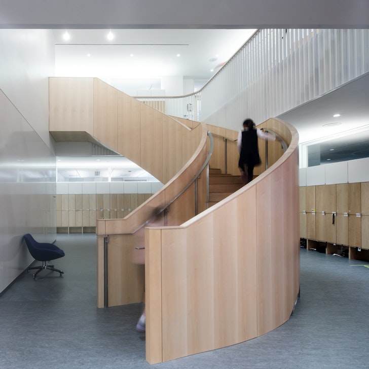 The interior spiral wood staircase linking two floors of the lower school creating a school within a school.