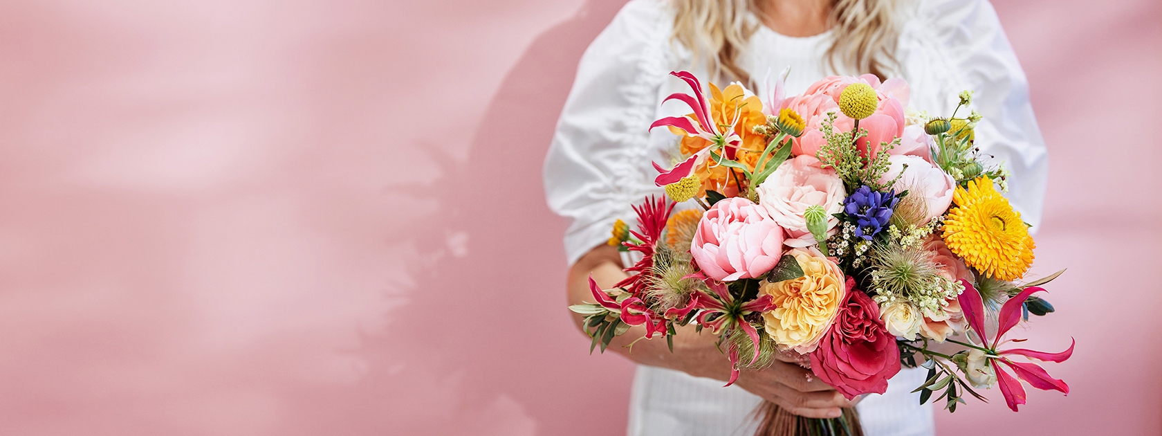 Bouquet in Hand in front of woman