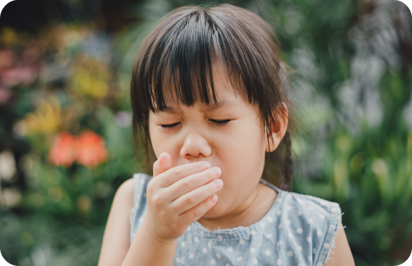 girl covering mouth coughing
