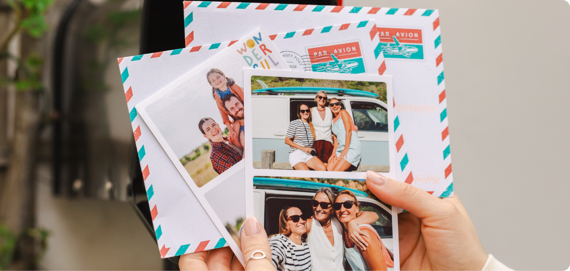 Hands holding TouchNote postcards