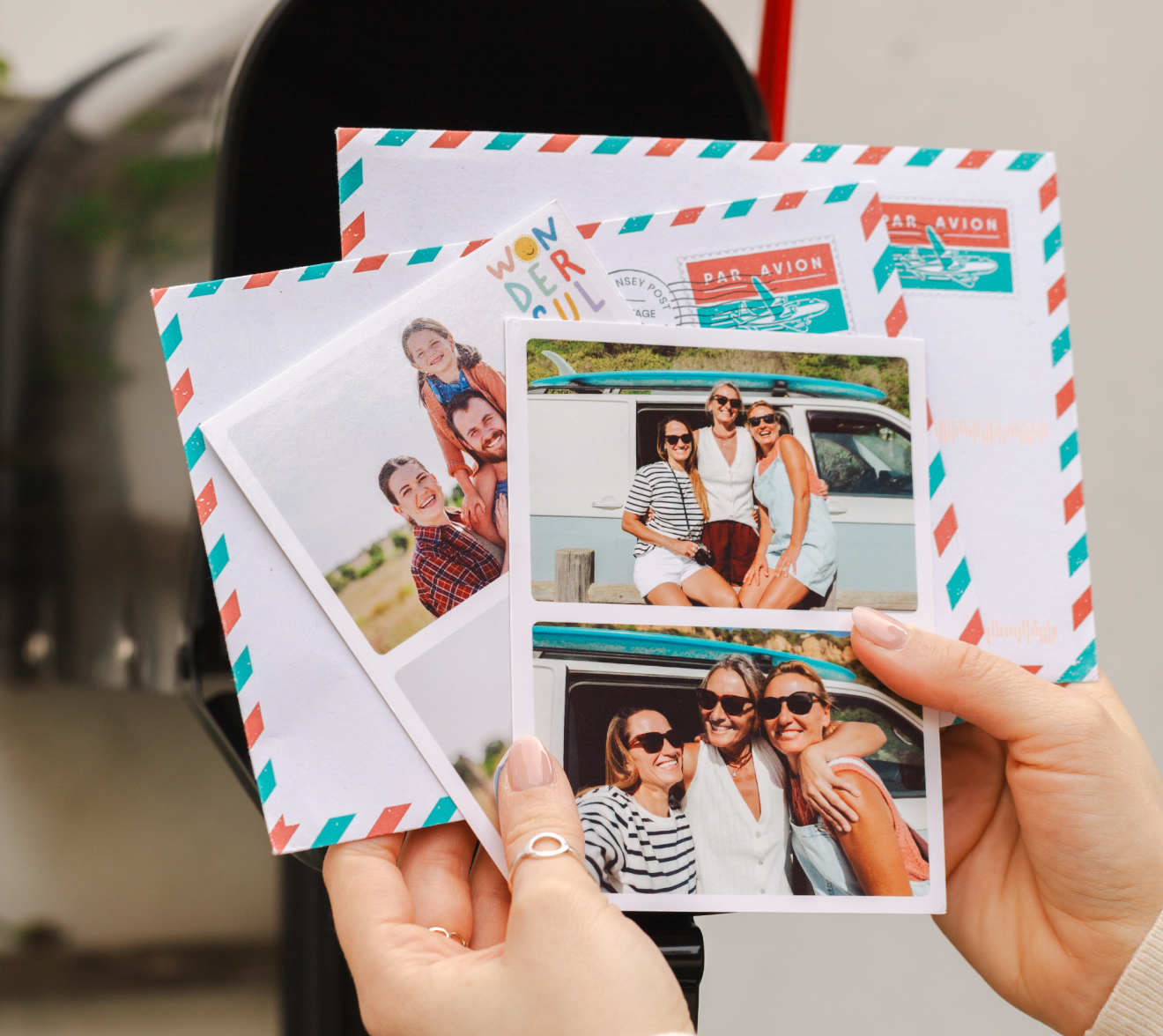 Hands holding TouchNote postcards
