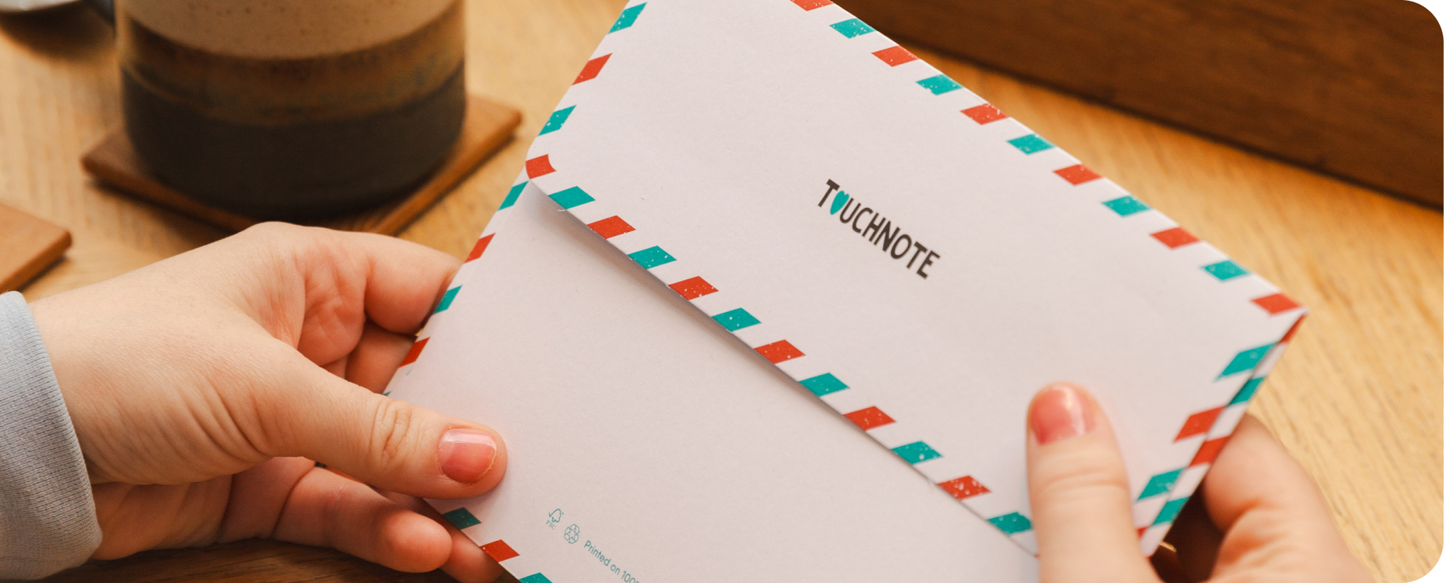 Hand holding a TouchNote envelope