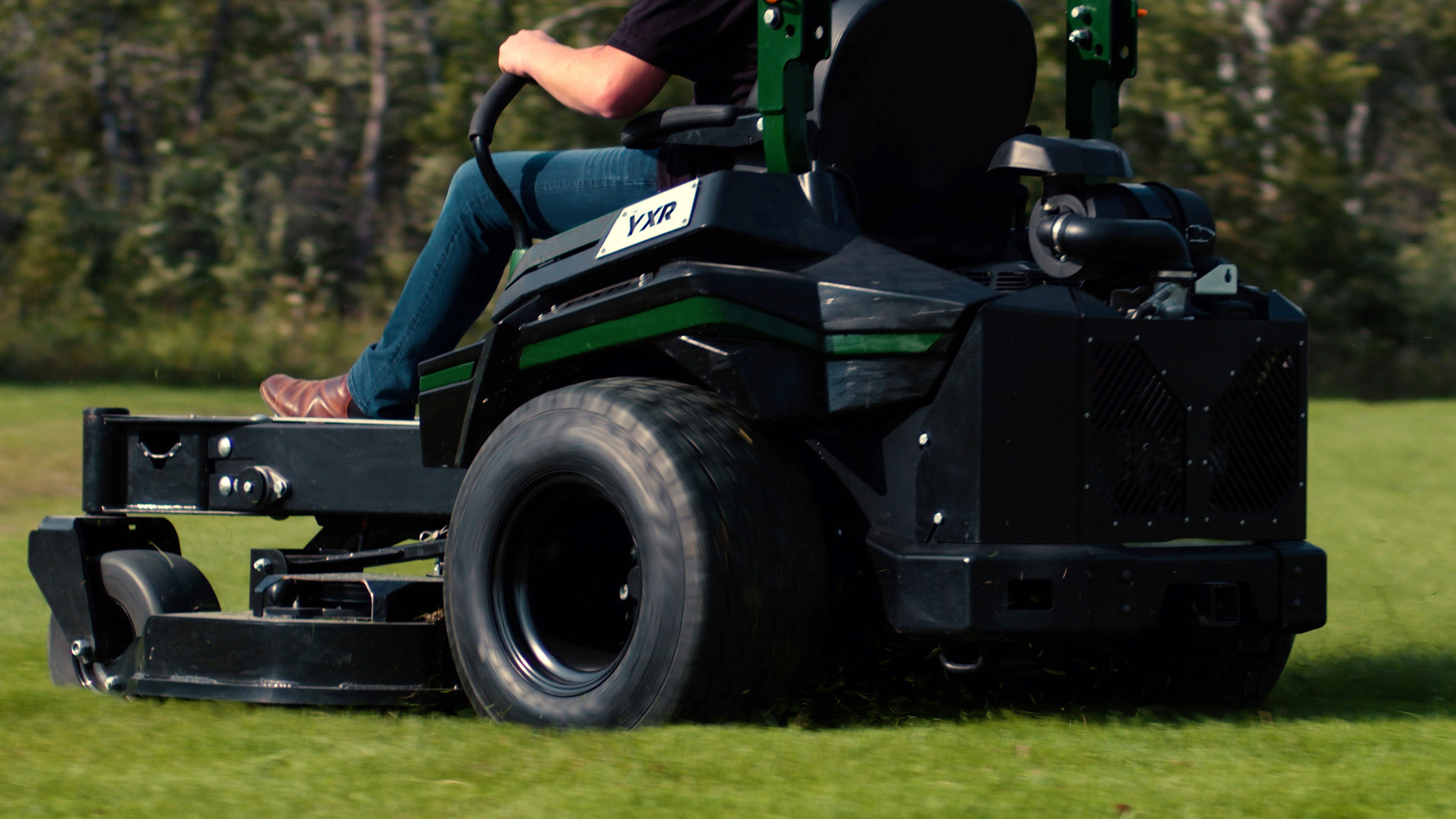 Commercial user driving fast zero-turn mower