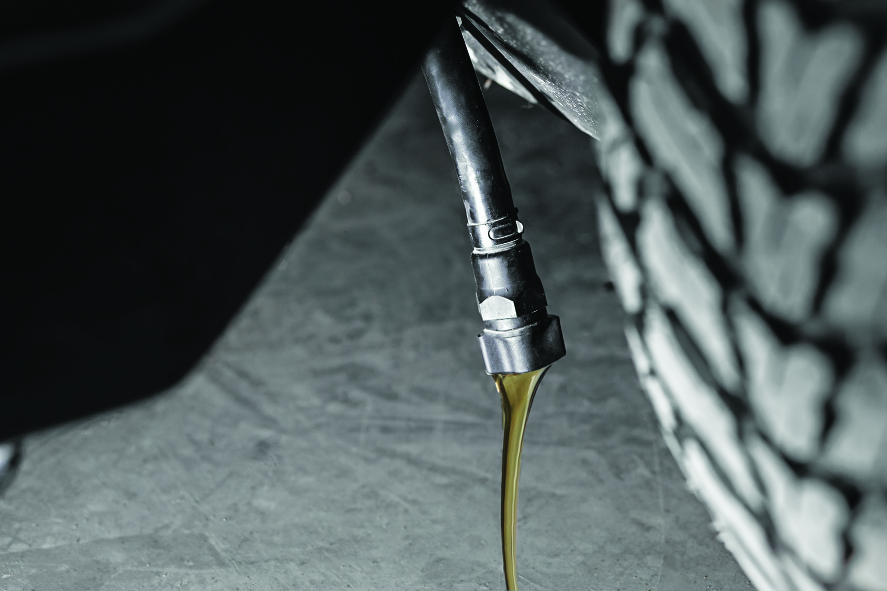 Yakta's Tool-Free Drain Hose pouring out oil
