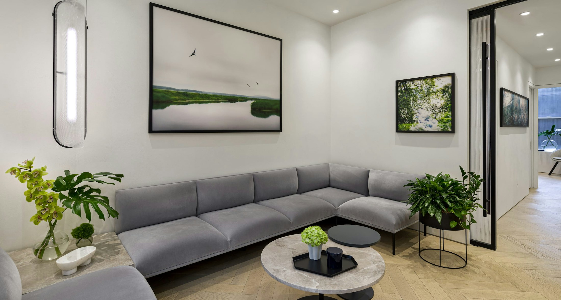 Waiting room with couch, small coffee table and plants