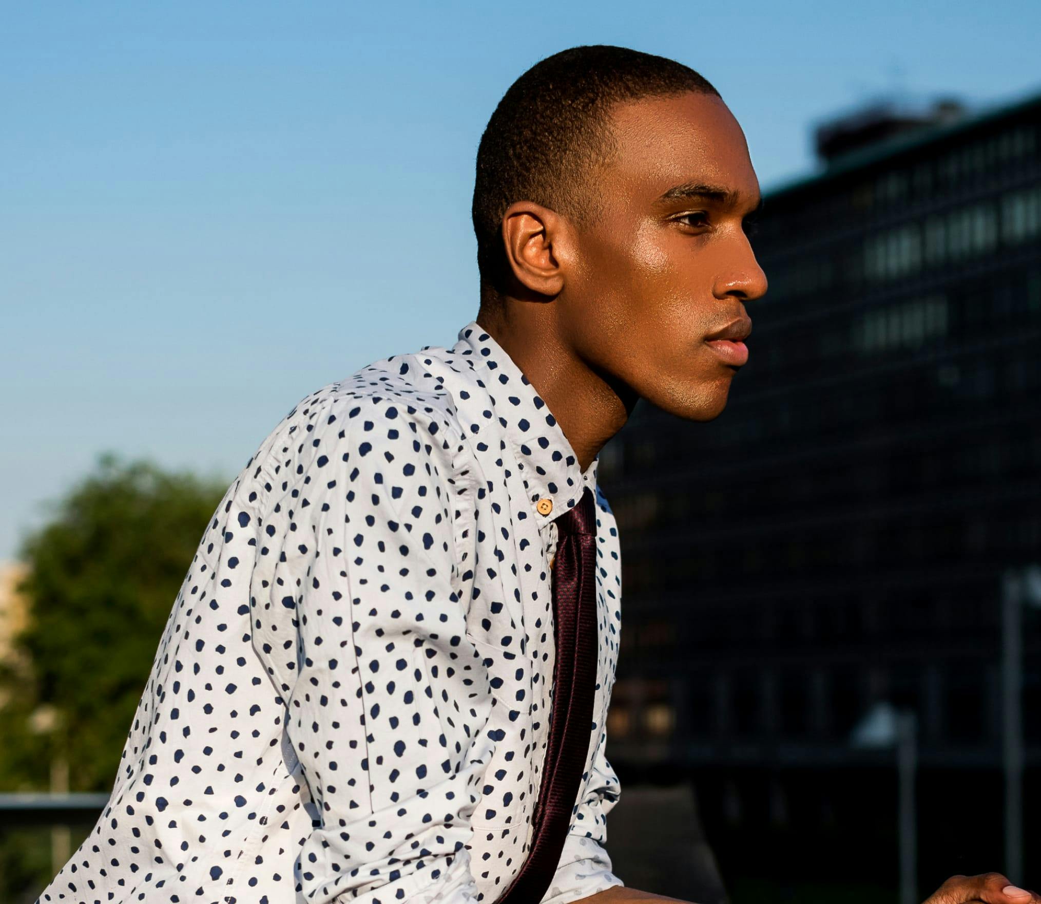 Man in Collared shirt looking off into the distance