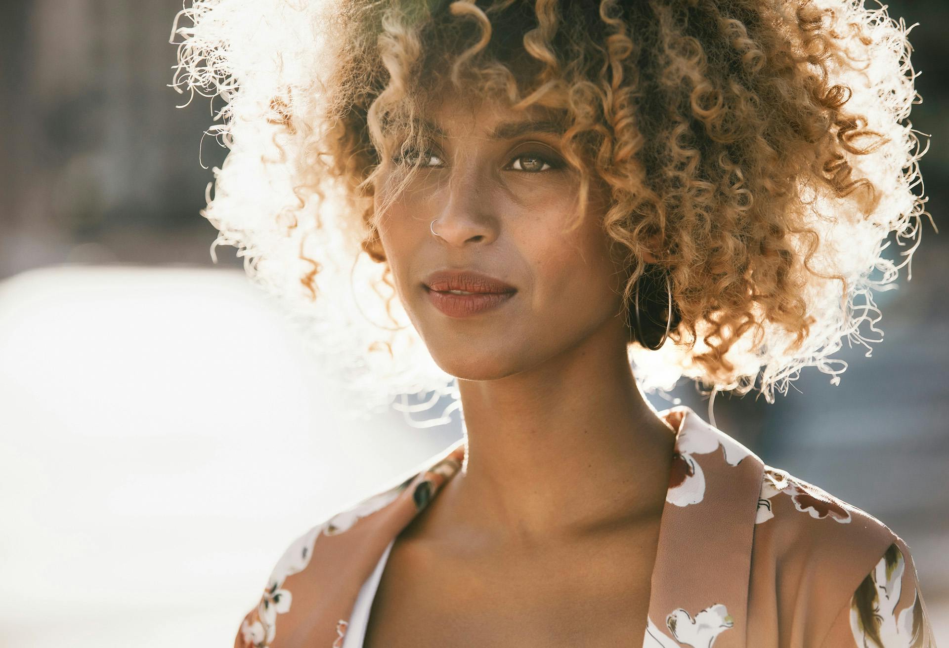 Woman with very curly hair outside