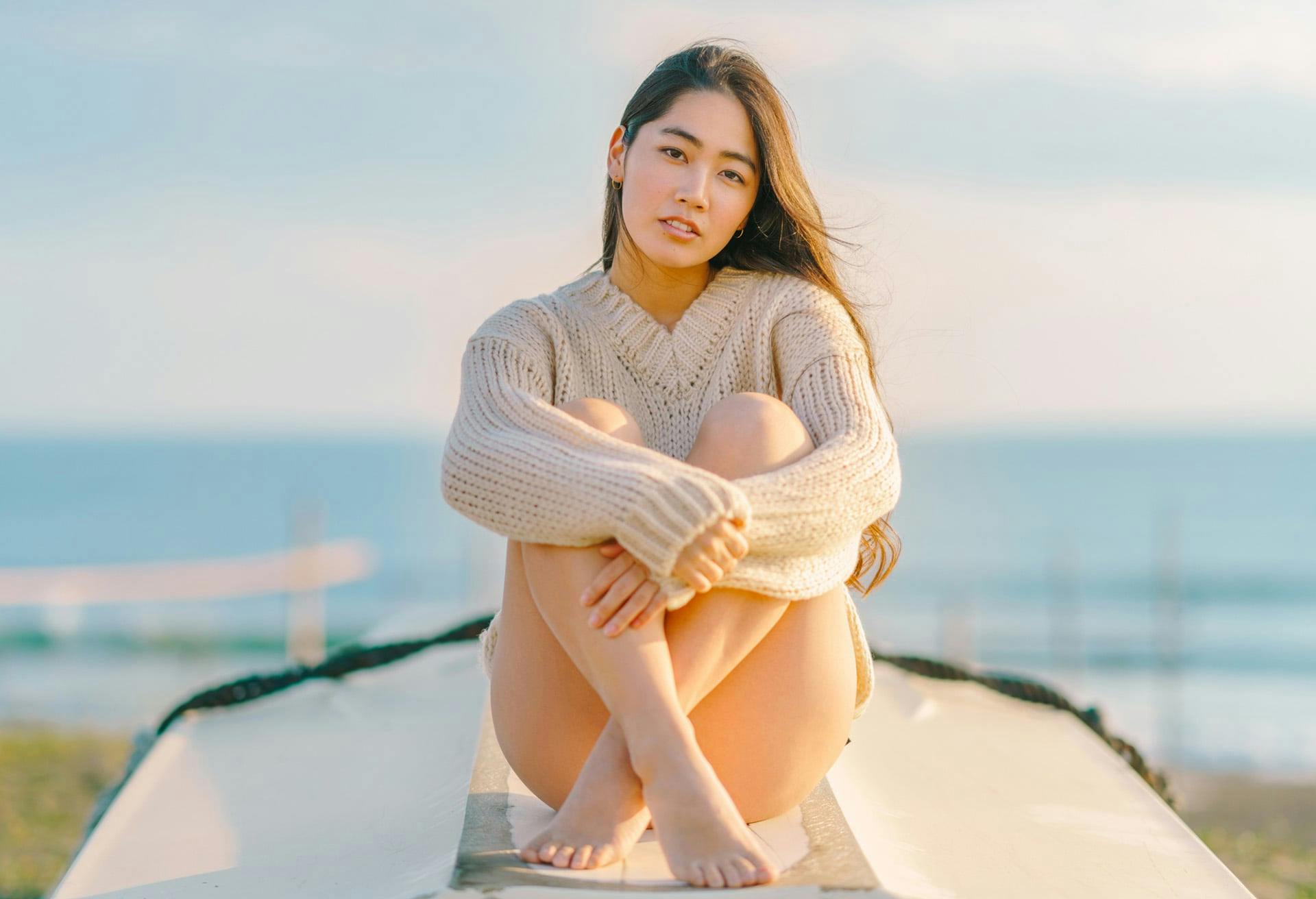 Woman sitting down wearing a knitted sweater