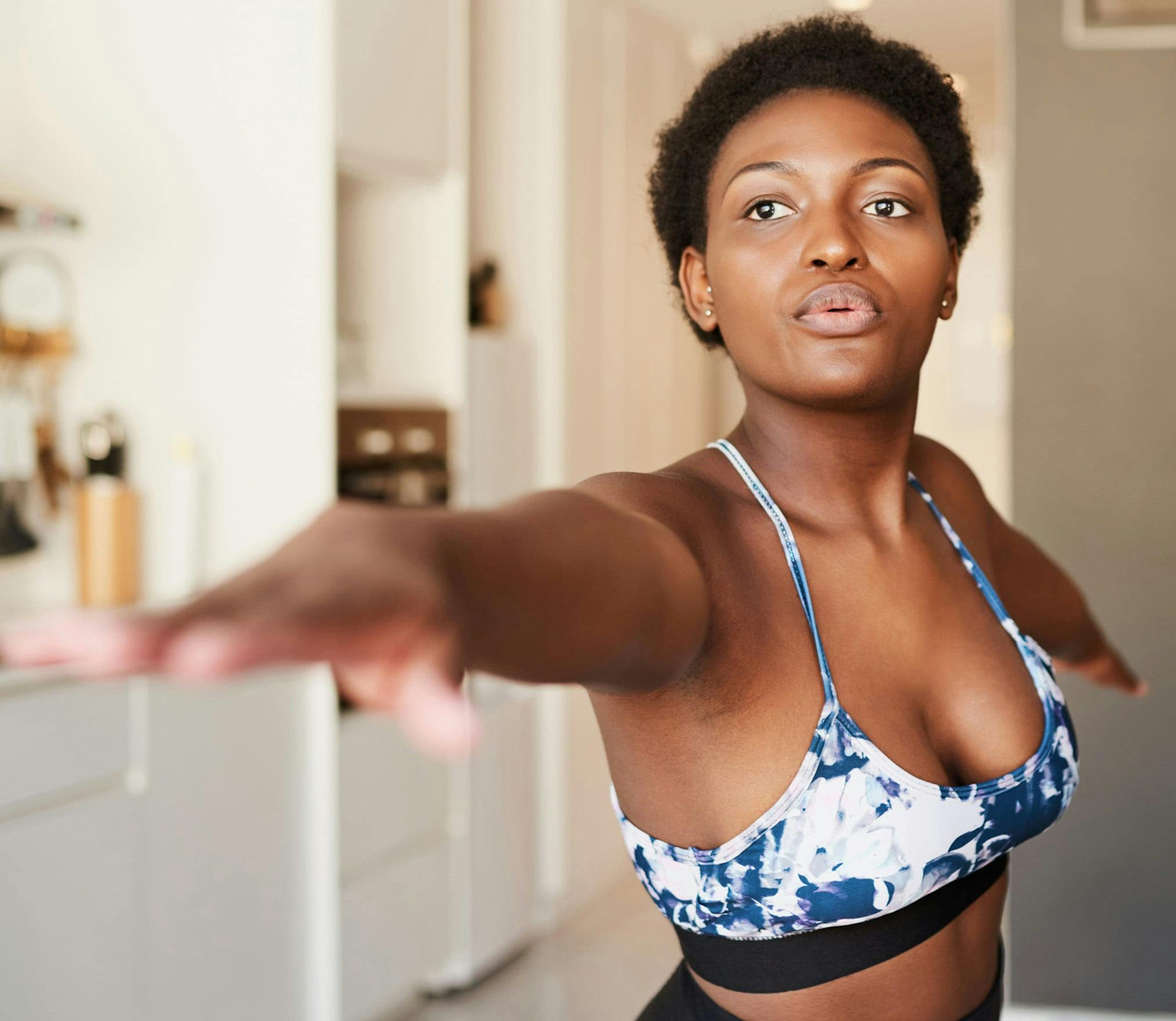 Woman doing yoga after receiving breast augmentation