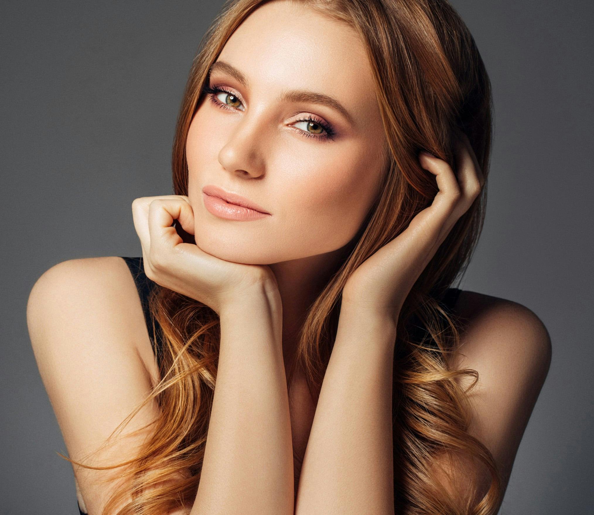 woman with long red hair posing for a picture