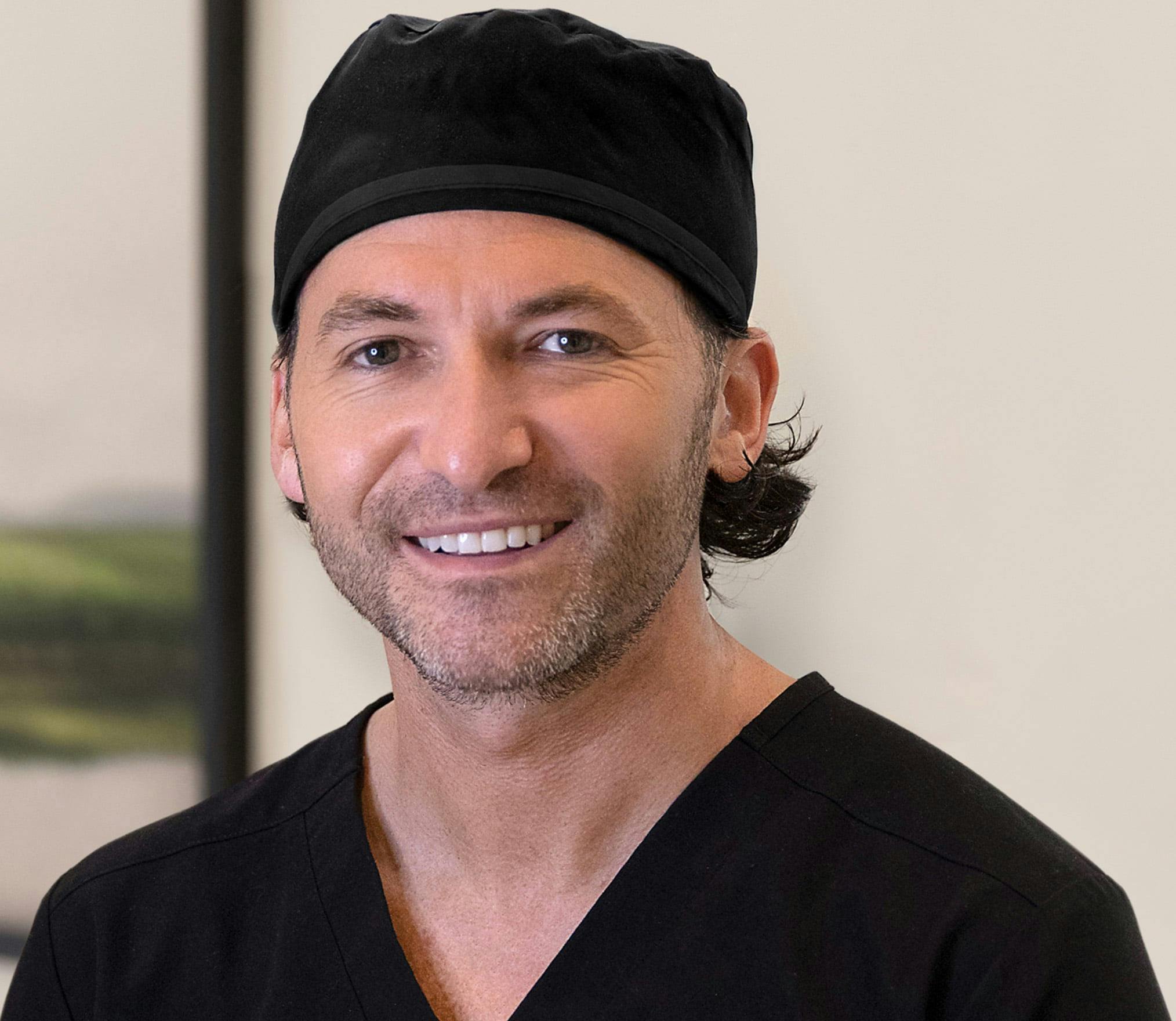 Dr. Albert in black scrubs