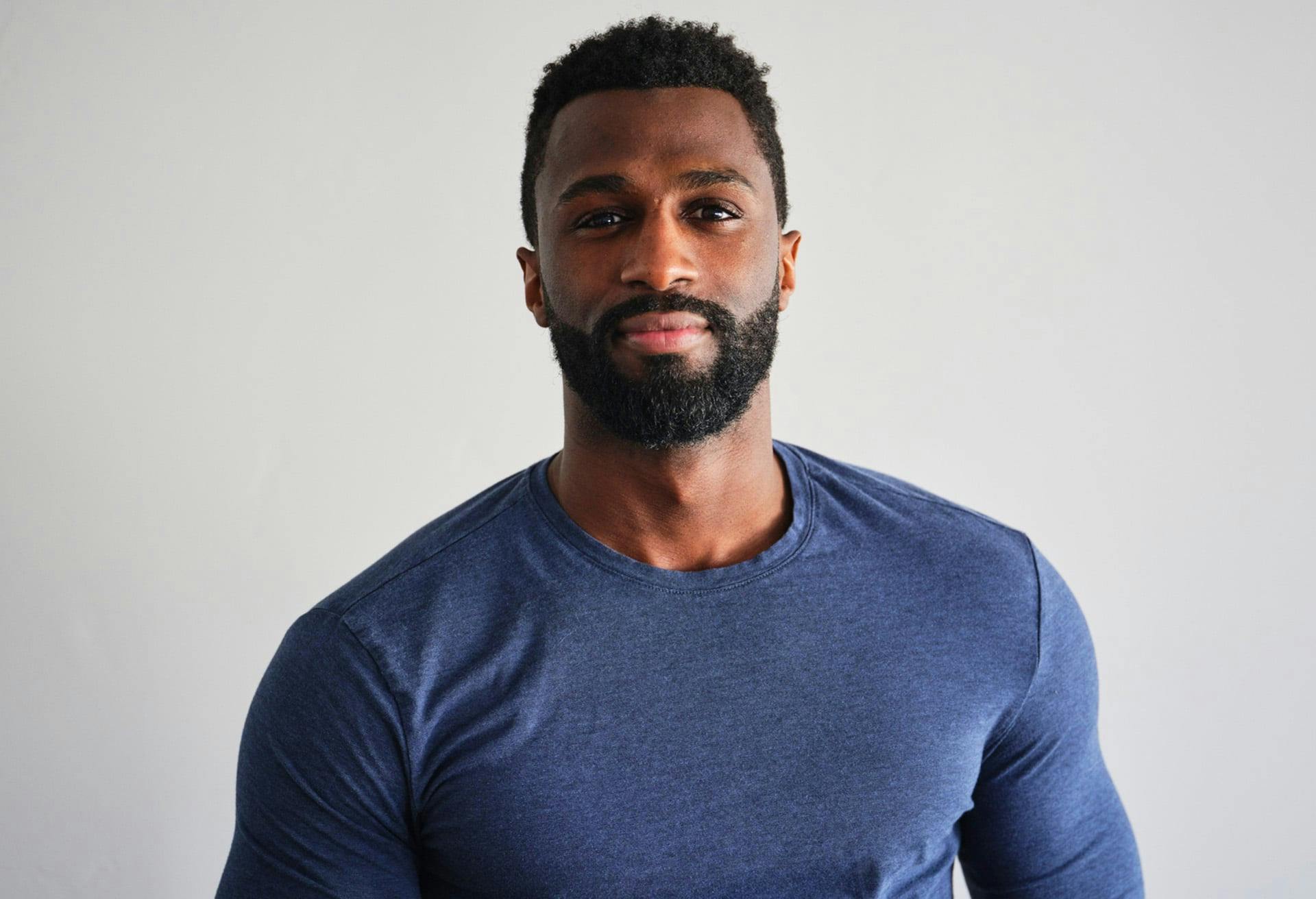 Man with facial hair wearing a navy shirt