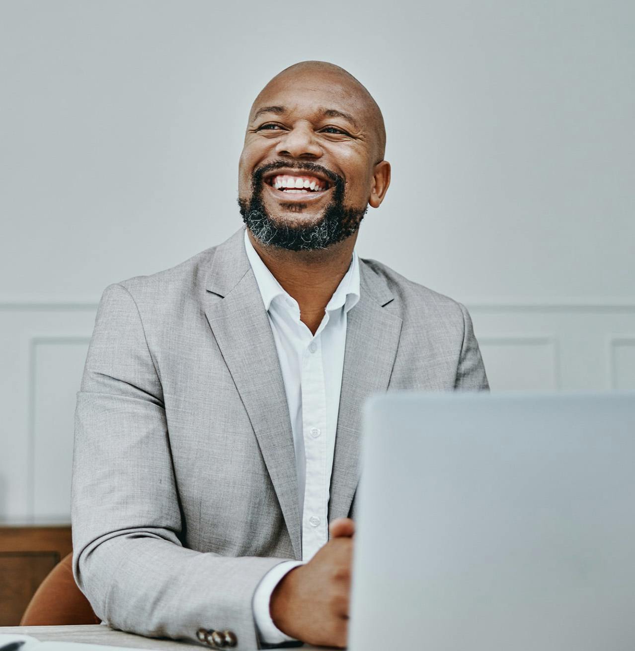 Man wearing a grey suit smiling