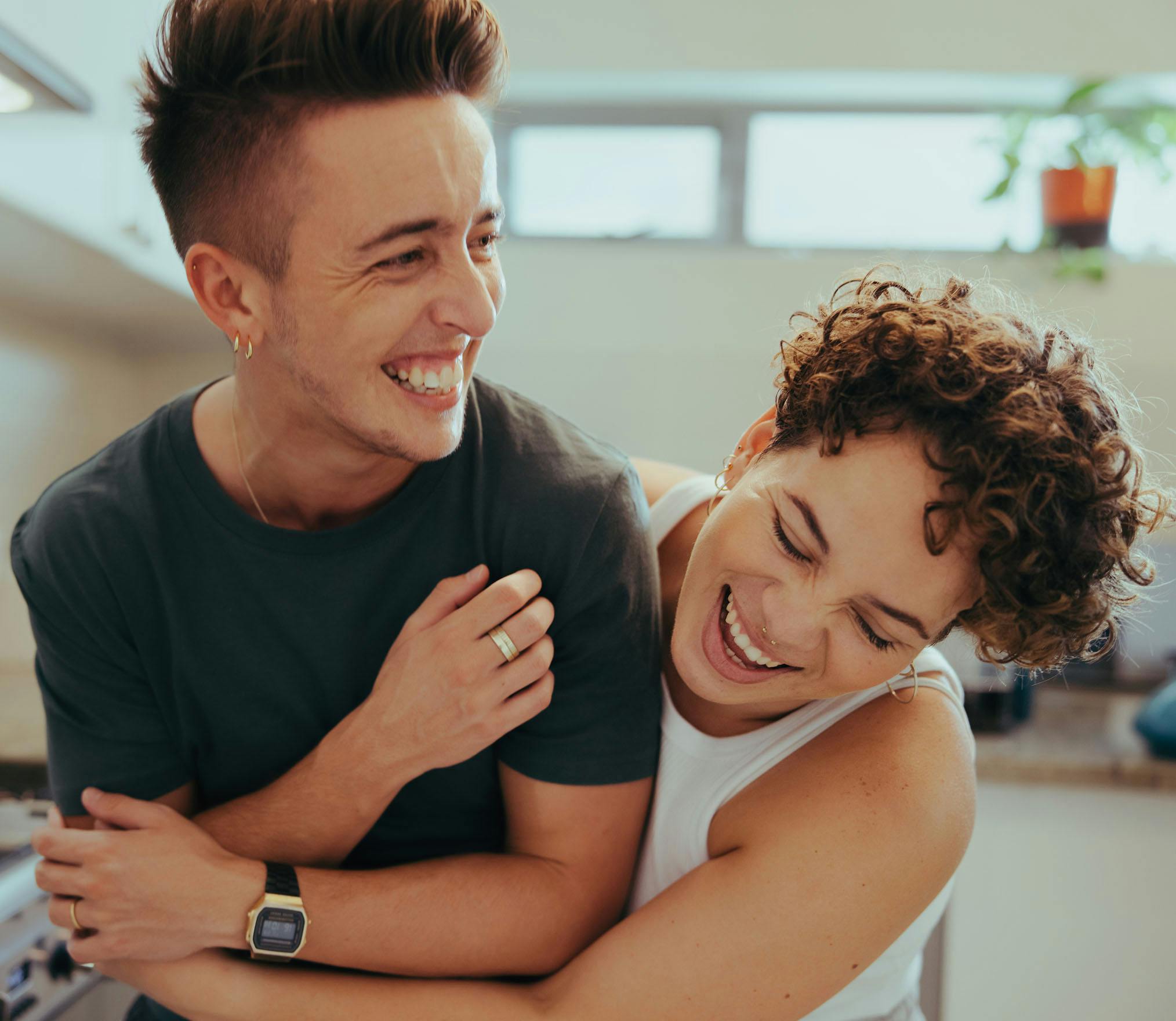 there is a man and woman hugging each other in a kitchen