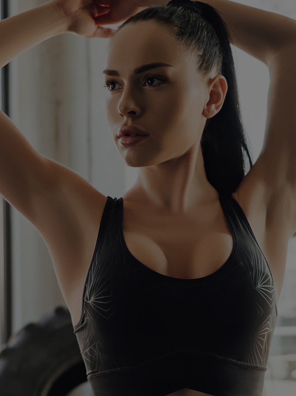 Woman with her hair up wearing a sports top