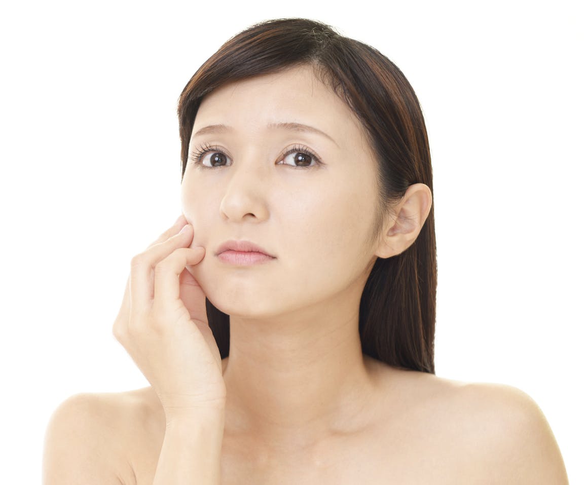 there is a woman that is looking worried while touching face