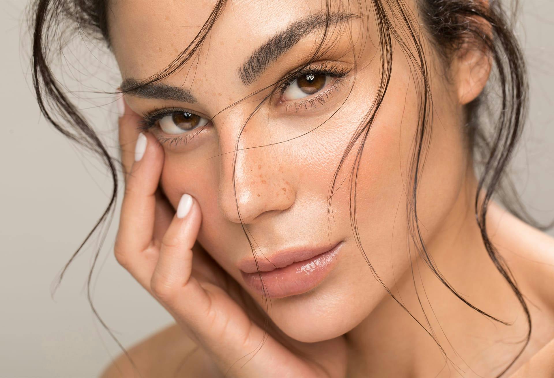 woman with hand on face