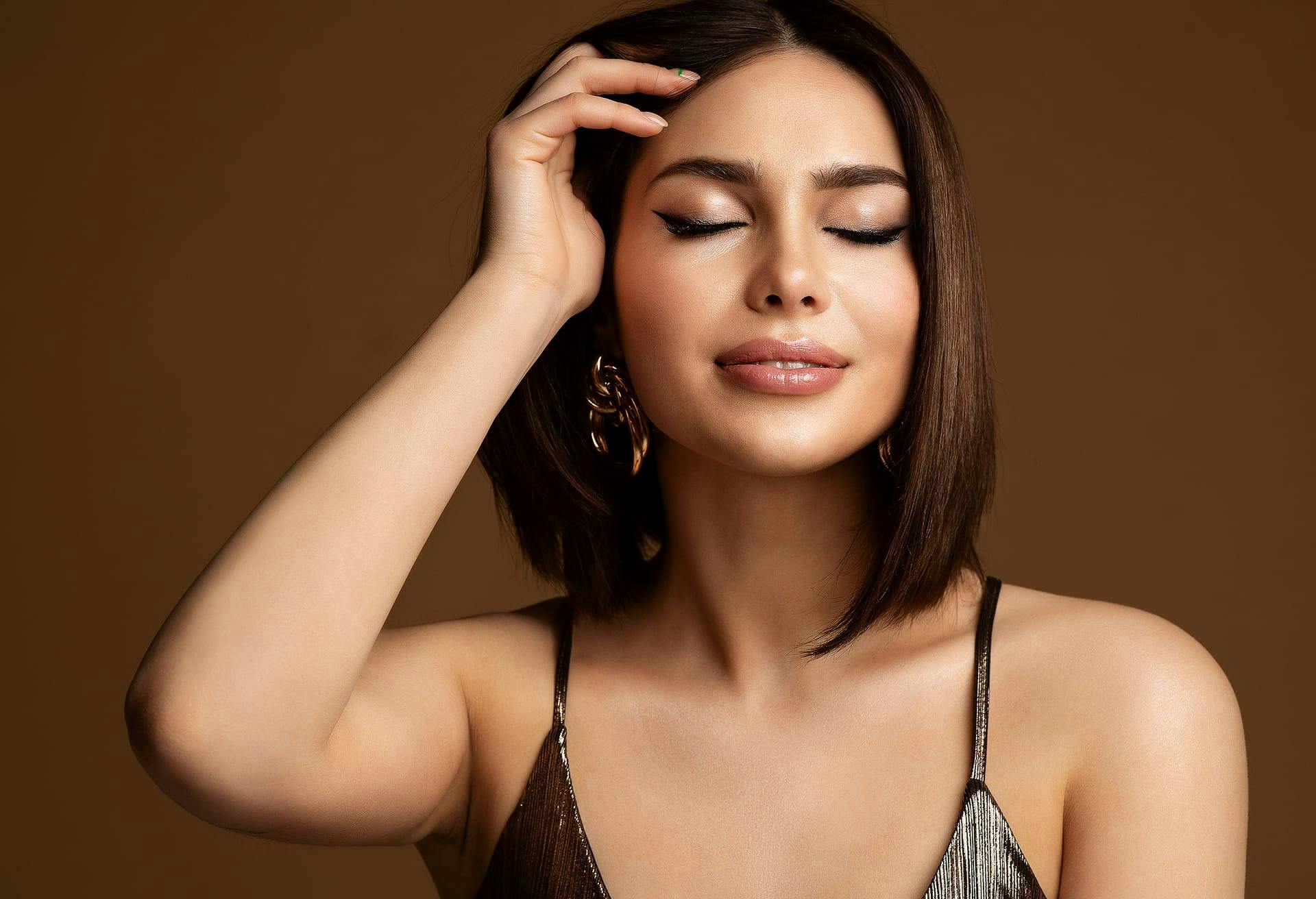 beautiful woman smiling and pulling hair back
