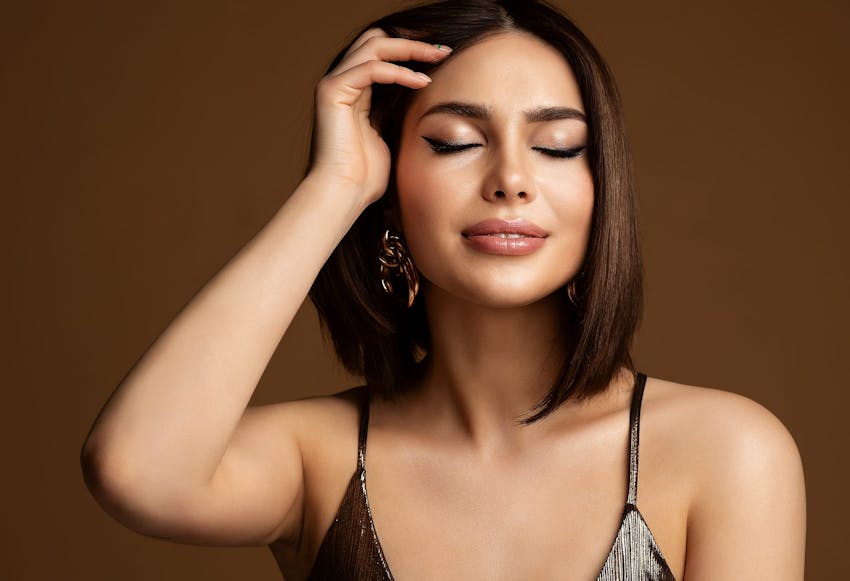 beautiful woman smiling and pulling hair back