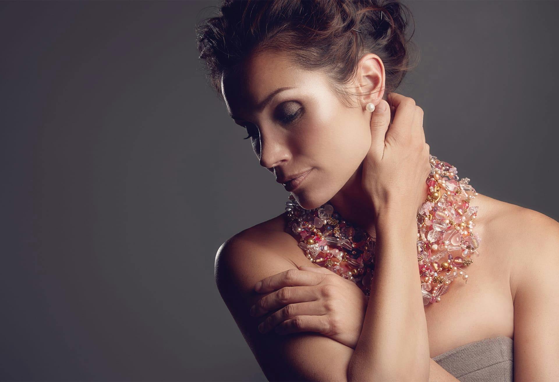 Woman holding neck and looking down