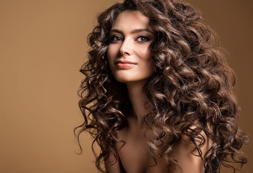 woman with curly hair smiling