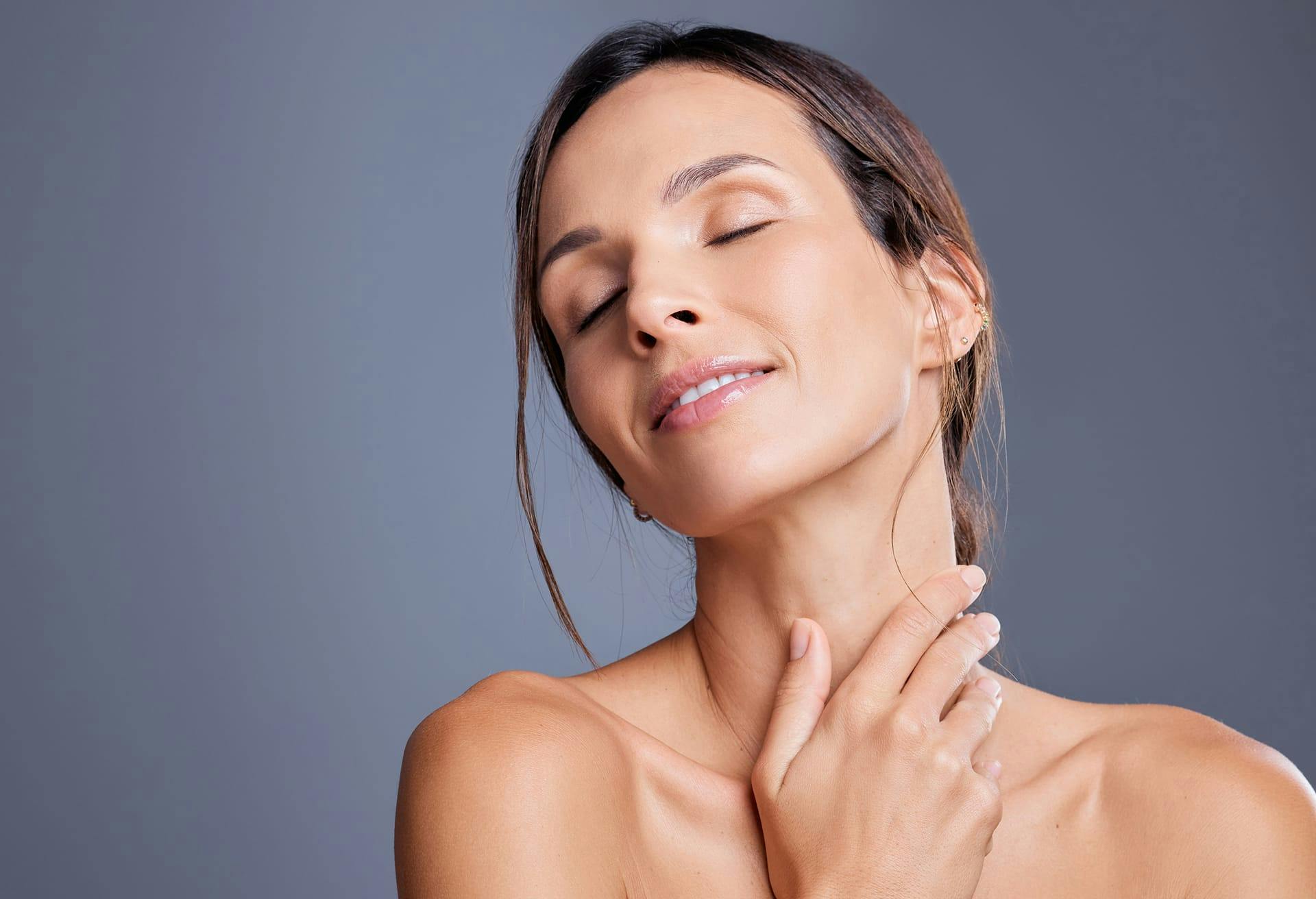 woman holding neck