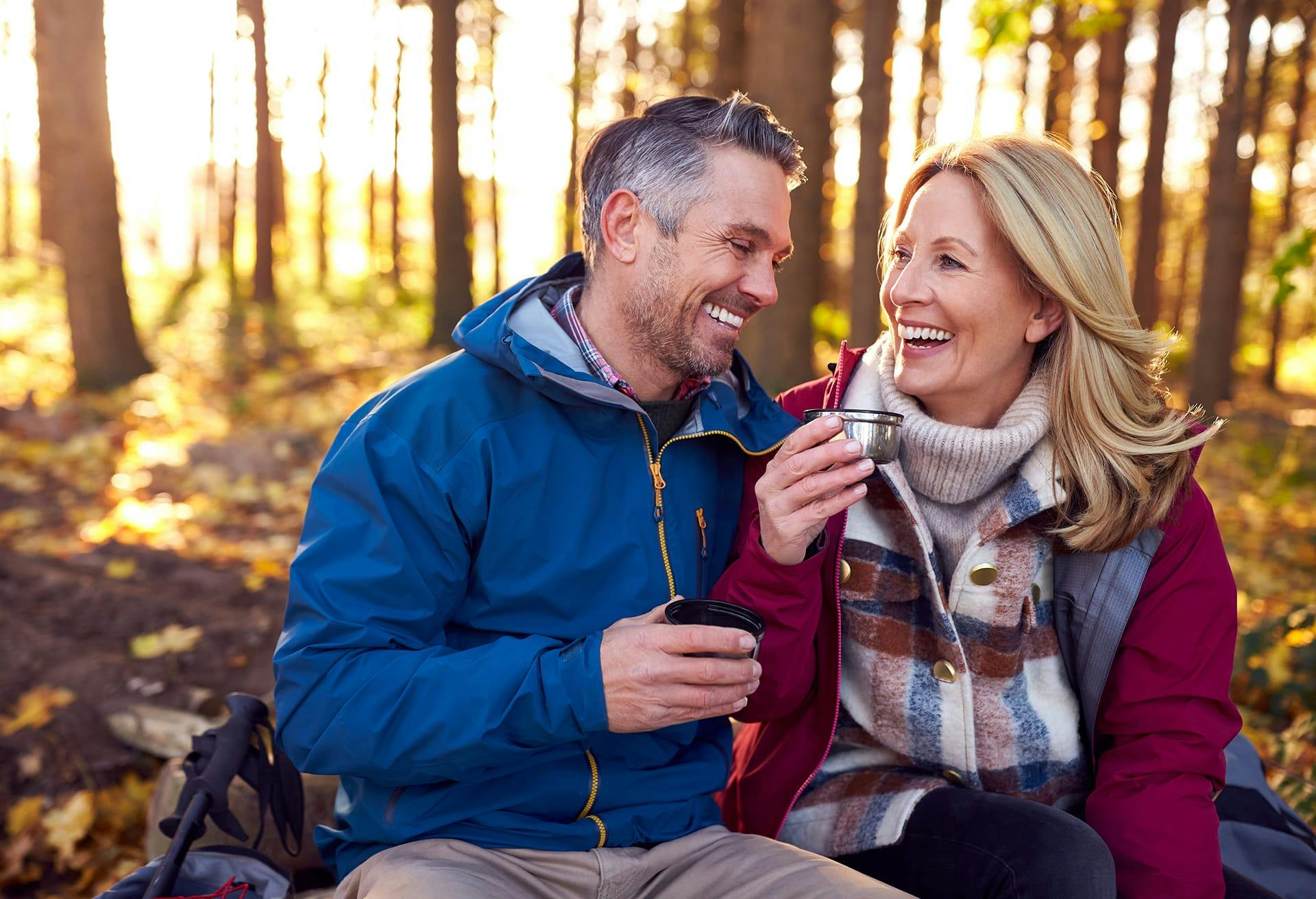 Man and woman sitting together in a forest