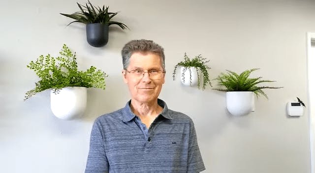 Man in front of plants