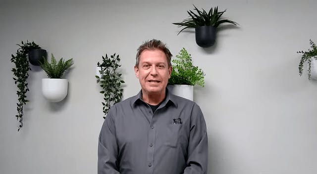 Man in front of plants
