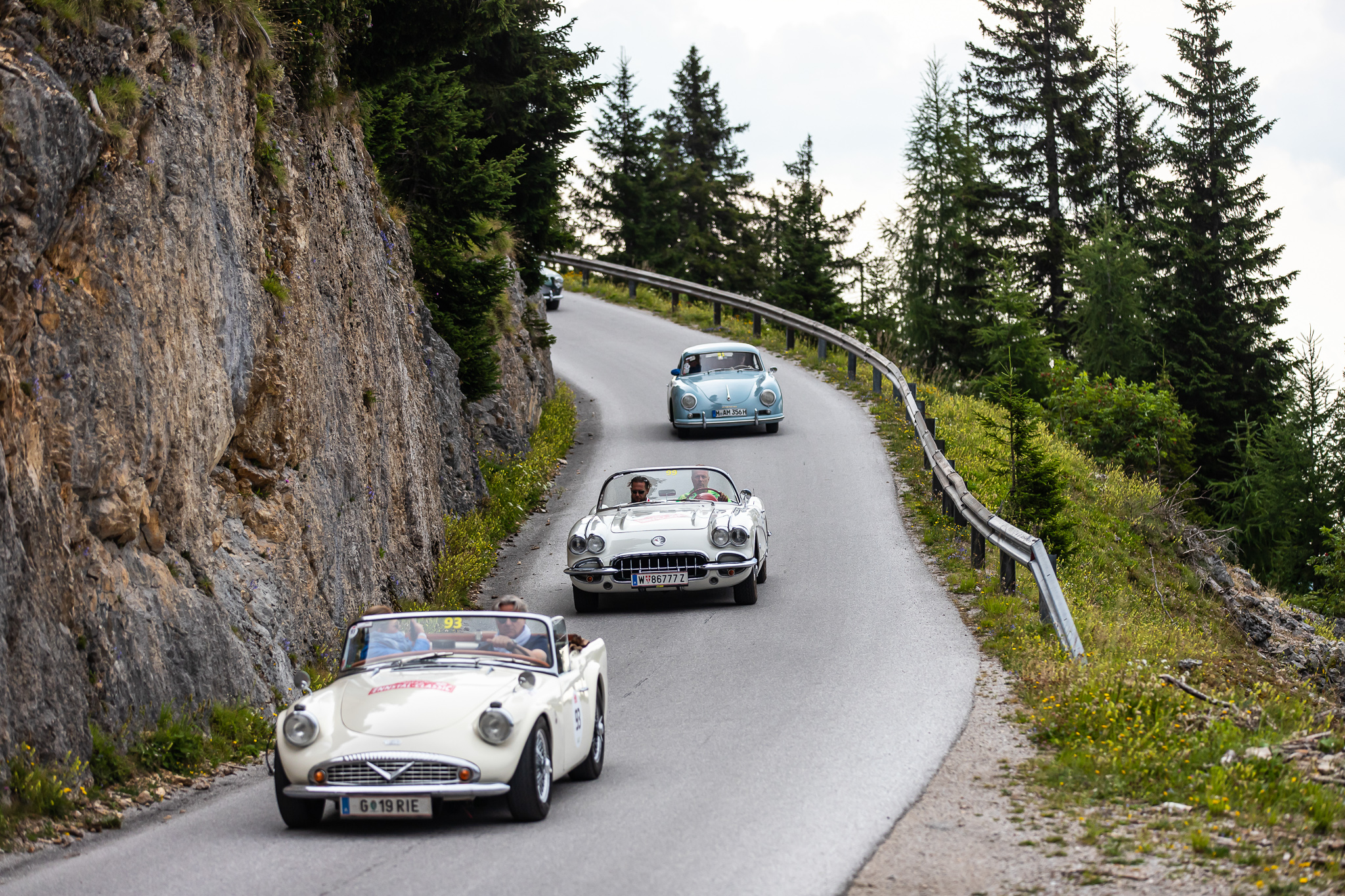 Classic cars driving on a winding mountain road during Ennstal-Classic rally — BUBEN&ZORWEG