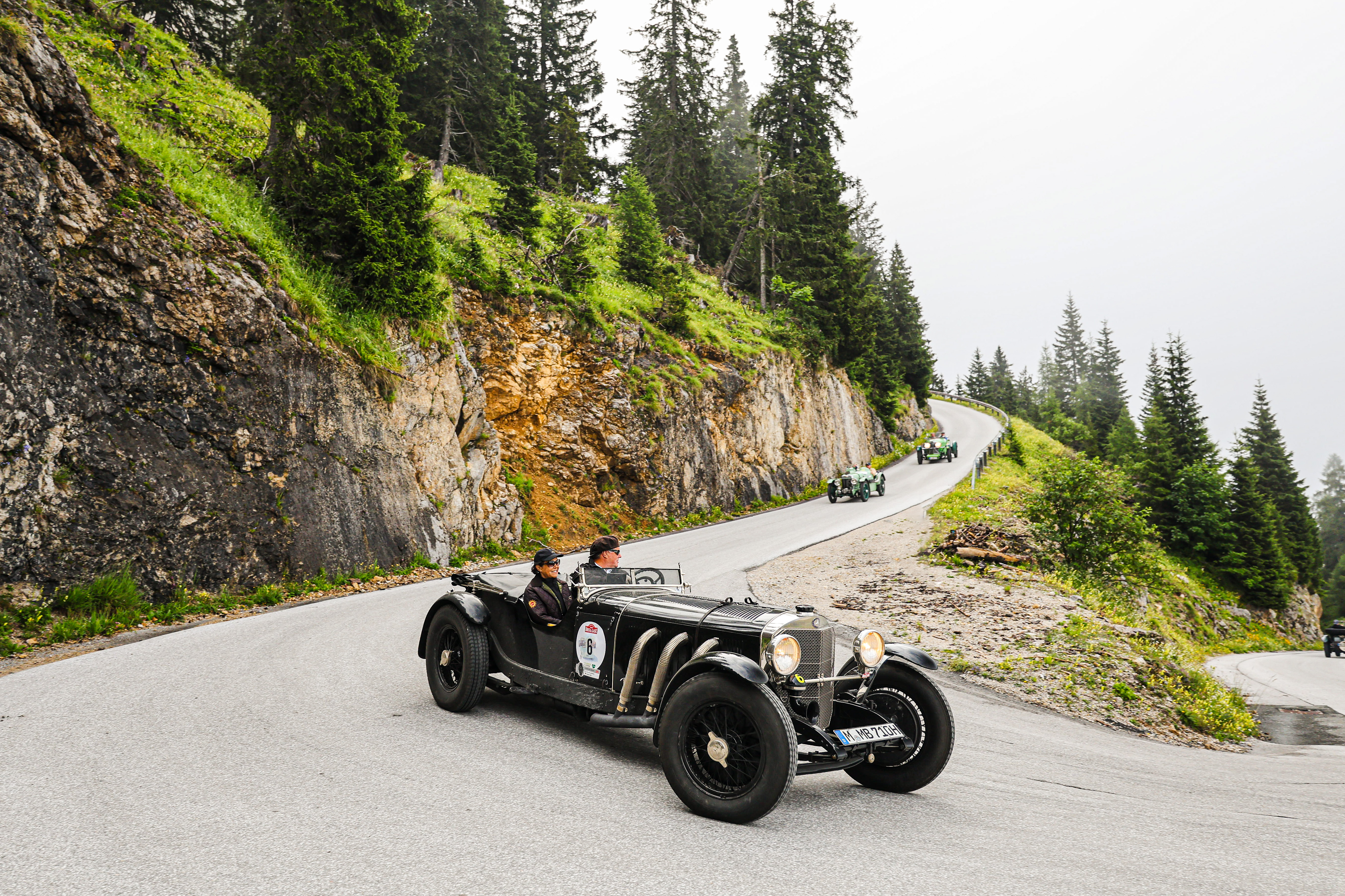 Classic car driving on winding mountain road during Ennstal-Classic rally — BUBEN&ZORWEG