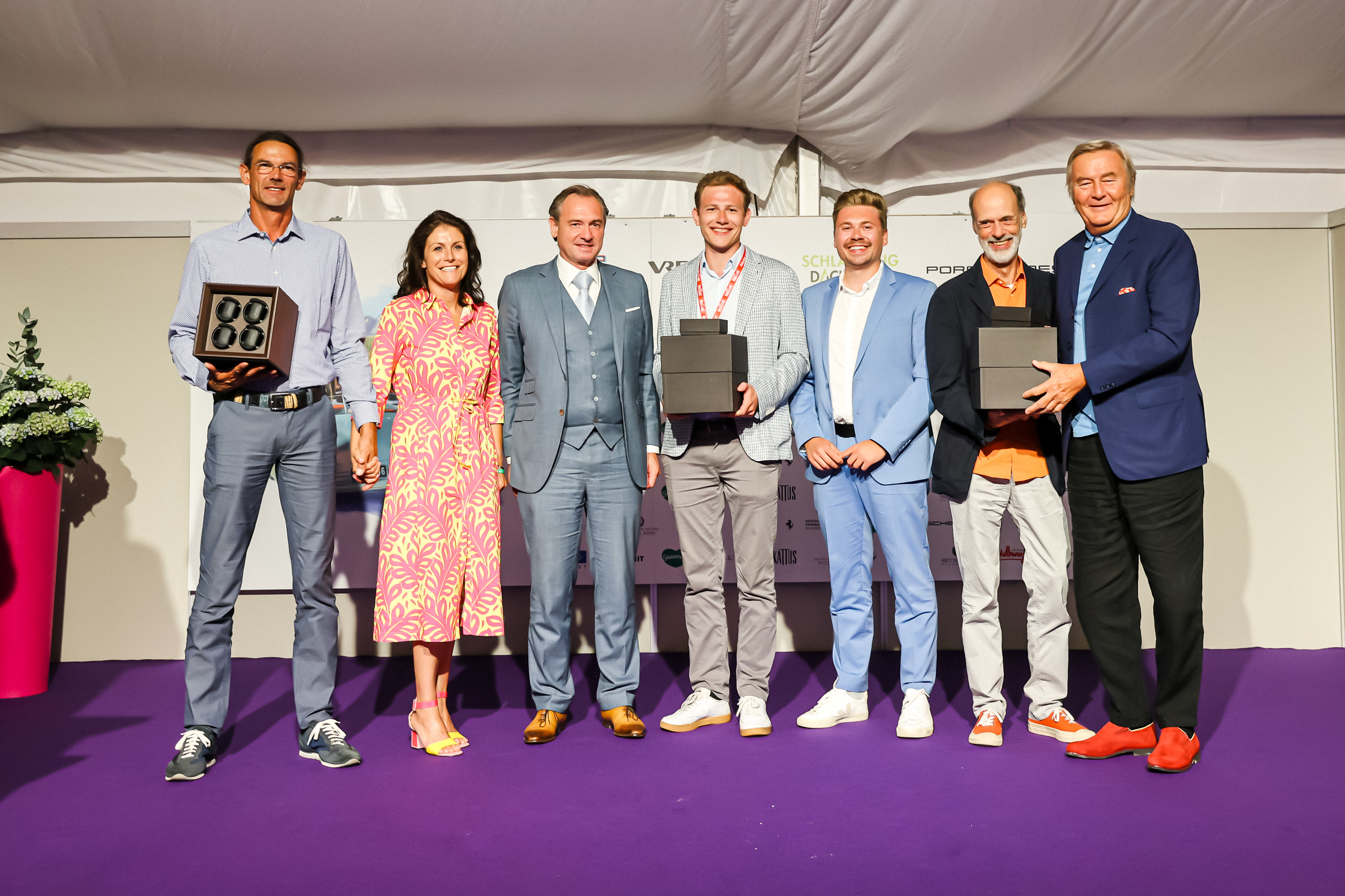 Award ceremony at Ennstal-Classic rally with winners holding BUBEN&ZORWEG boxes — BUBEN&ZORWEG