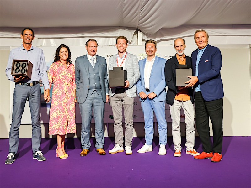 Award ceremony at Ennstal-Classic rally with winners holding BUBEN&ZORWEG boxes — BUBEN&ZORWEG