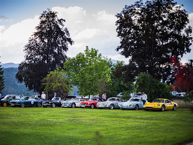 Classic cars lined up on a lawn at the Ennstal-Classic rally event — BUBEN&ZORWEG