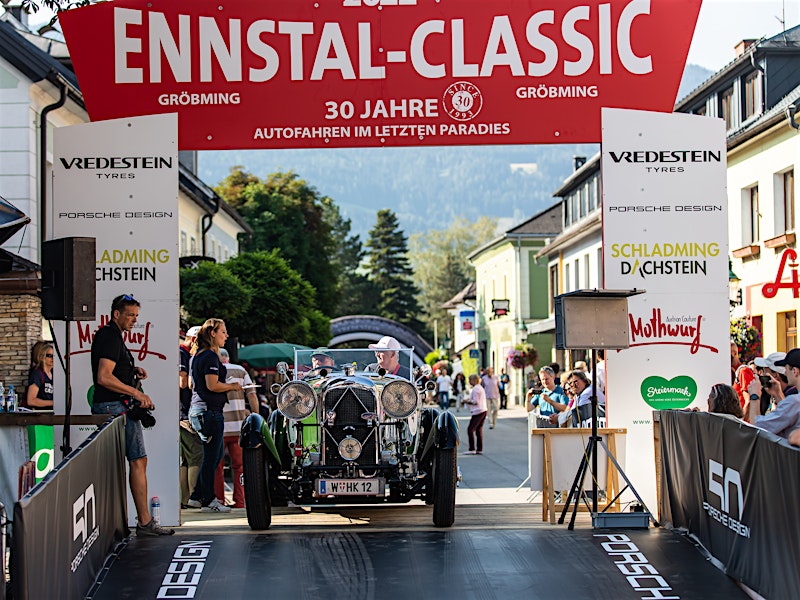 Classic car crossing the start line at the 30th Ennstal-Classic rally in Gröbming, Austria — BUBEN&ZORWEG