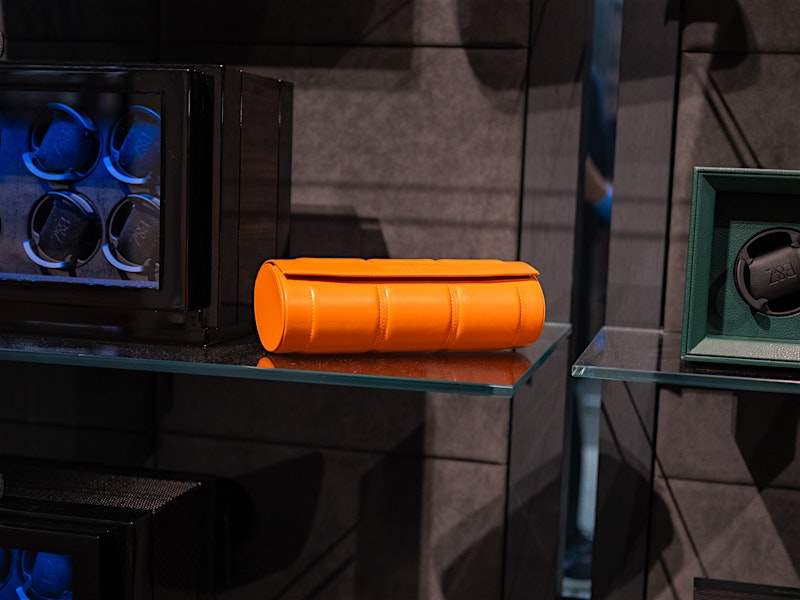 Orange leather watch roll on glass shelf — BUBEN&ZORWEG
