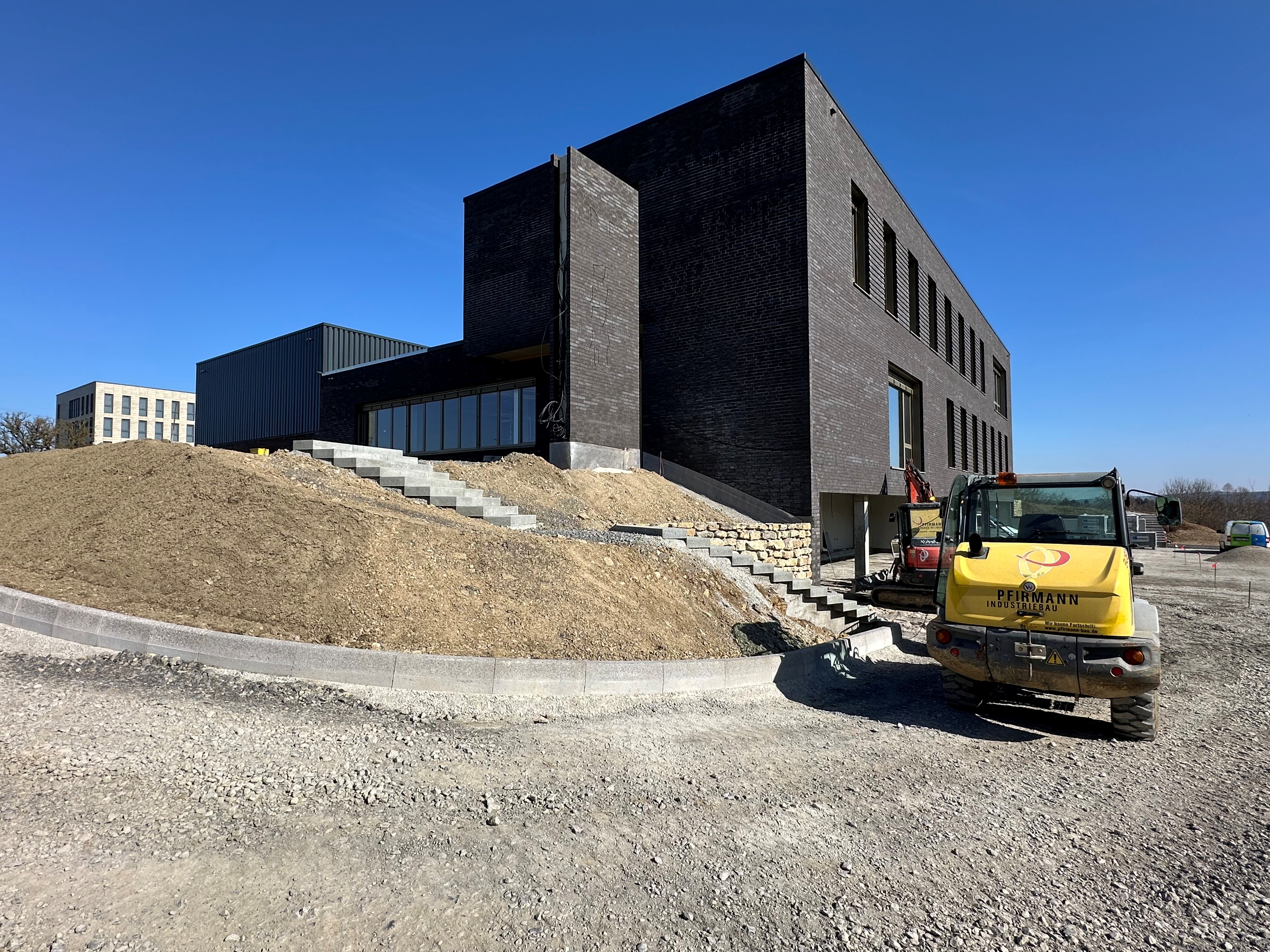Dark brick building with staircase under construction — BUBEN&ZORWEG