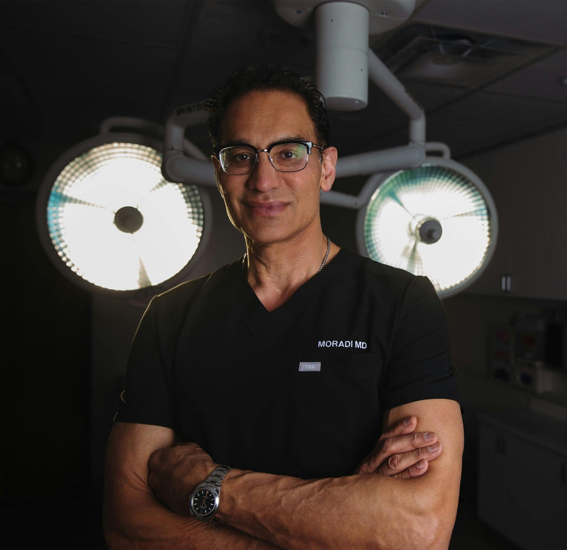Dr. Moradi standing in front of operating lights