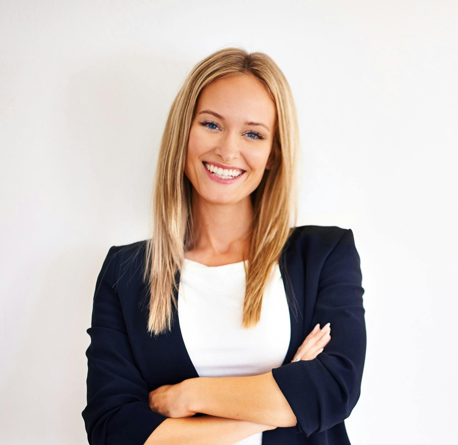 woman with blonde hair and white shirt smiling at the camera