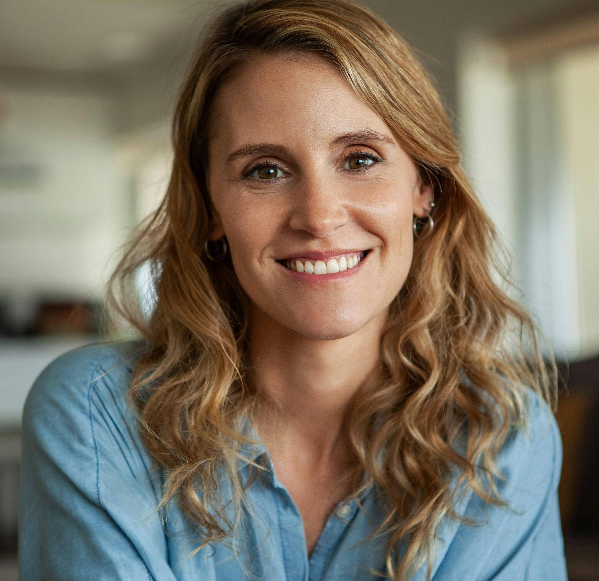 woman smiling with a blue shirt on