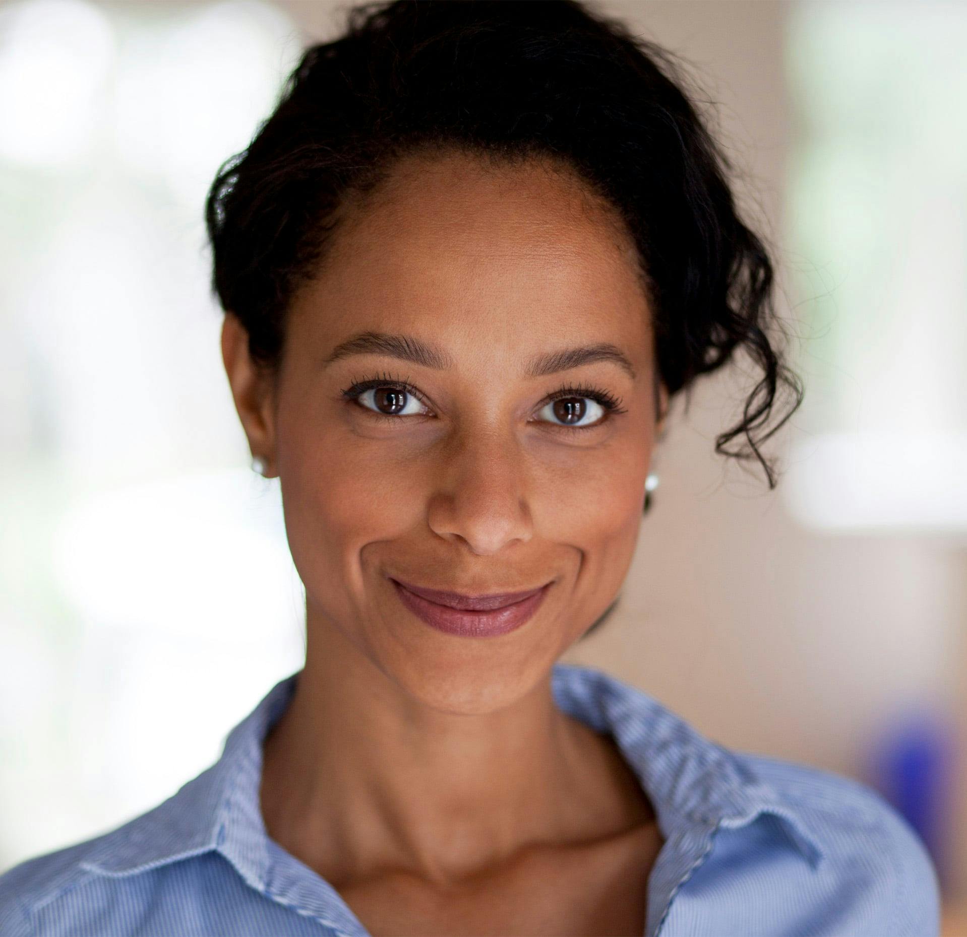 woman with black hair brown eyes and blue shirt on
