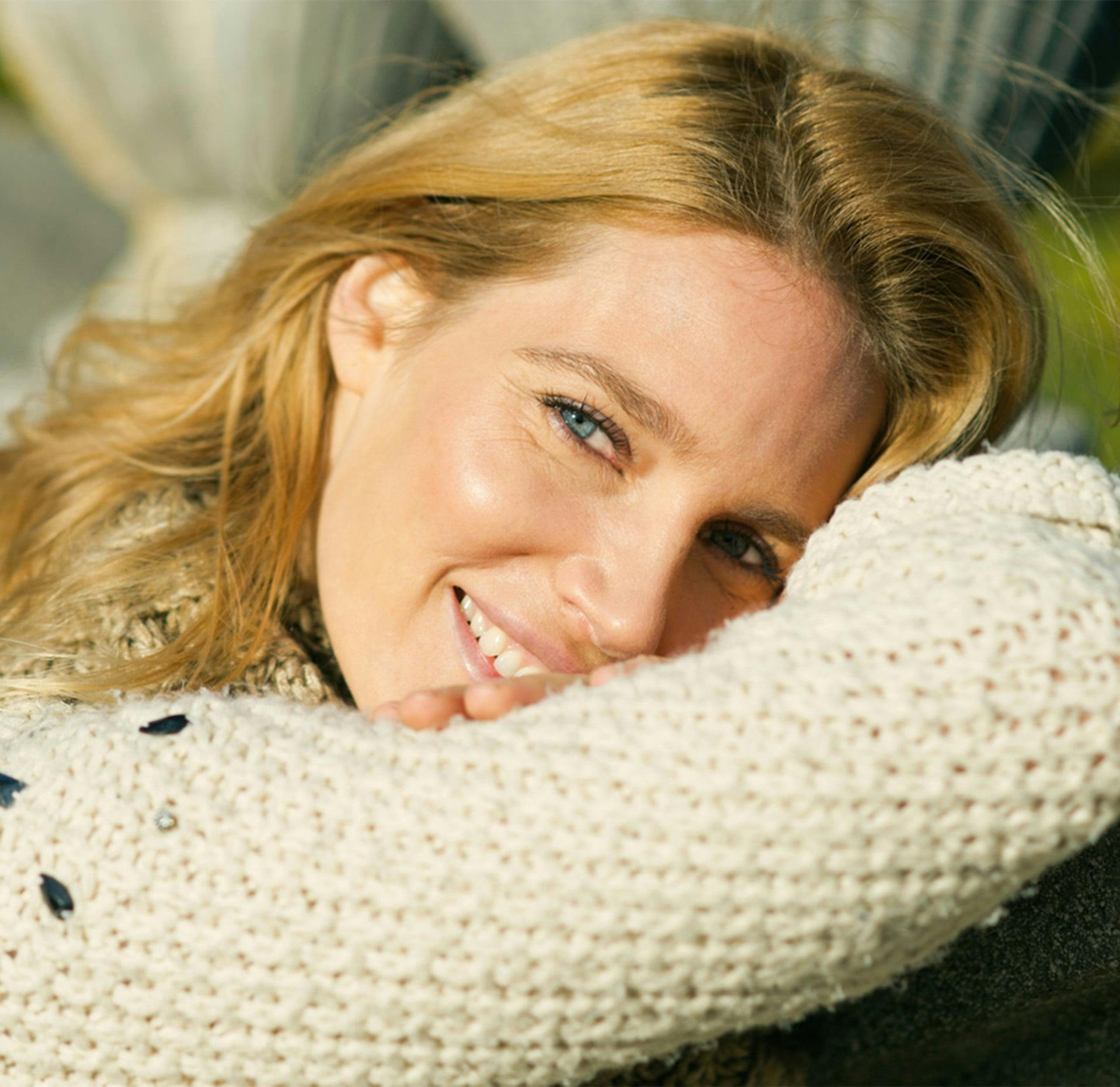 Woman lying down with her head against her arm